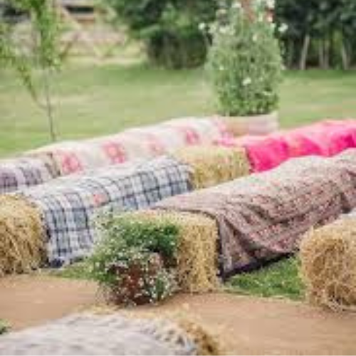 Rows of square bales covered by decorative blankets